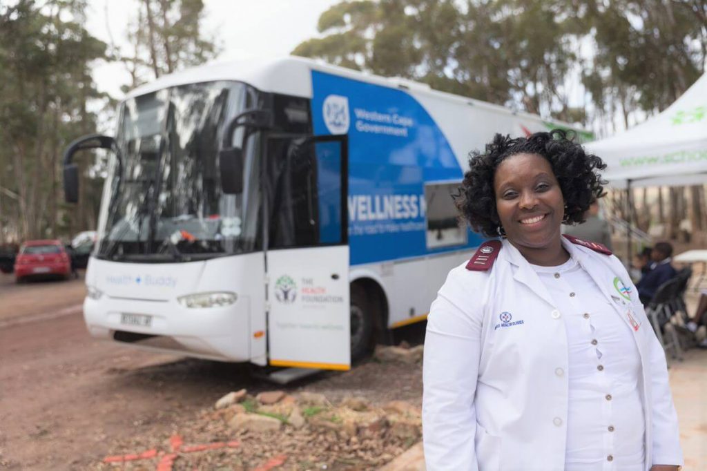 Nurse next to mobile clinic