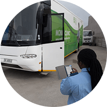 Operator checking schedule outside mobile unit