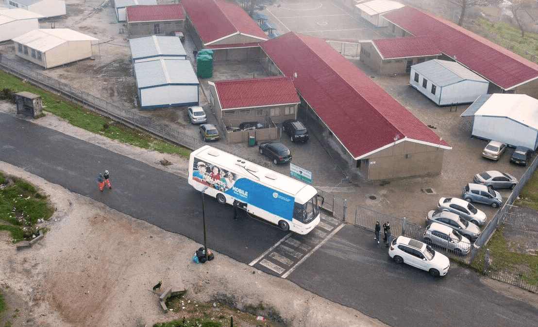Mobile health clinic arriving at a school